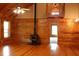 Living room featuring wood walls and floors, fireplace, loft area, and ceiling fan at 512 E Valley Ne Rd, Rydal, GA 30171