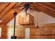 Cozy living room with wood walls, a fireplace, loft, and chandelier at 512 E Valley Ne Rd, Rydal, GA 30171