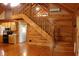 Open-concept area showcasing wood floors, a staircase to a loft, and kitchen at 512 E Valley Ne Rd, Rydal, GA 30171