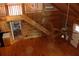 Open living room showcasing hardwood floors, wood paneling, and a staircase to the second level at 512 E Valley Ne Rd, Rydal, GA 30171