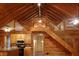Charming interior with vaulted ceilings, wooden beams, and staircase leading to the loft area at 512 E Valley Ne Rd, Rydal, GA 30171