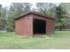 Open-ended shed with concrete flooring, siding, and green lawn at 512 E Valley Ne Rd, Rydal, GA 30171