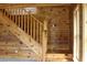 Wooden staircase with natural wood and rustic charm, leading to the upper level at 512 E Valley Ne Rd, Rydal, GA 30171