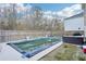 Backyard featuring a pool, patio area with outdoor seating, and a wood privacy fence at 939 Brittfield Way, Loganville, GA 30052