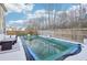Inviting backyard featuring a covered pool, lounge area, and wood fence for privacy at 939 Brittfield Way, Loganville, GA 30052