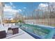 Inviting backyard featuring a covered pool, lounge area, and wood fence for privacy at 939 Brittfield Way, Loganville, GA 30052