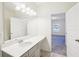 Bathroom features a white vanity with a large mirror, cabinet storage, and tile flooring at 939 Brittfield Way, Loganville, GA 30052