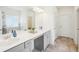 Modern bathroom with double sinks, quartz countertops, tile floors, and a large mirror at 939 Brittfield Way, Loganville, GA 30052