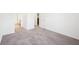 This bedroom features neutral carpet, baseboard, and trim, with views into other rooms of the house at 939 Brittfield Way, Loganville, GA 30052