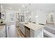 Spacious kitchen with stainless appliances, center island, and a view into the carpeted living room at 939 Brittfield Way, Loganville, GA 30052