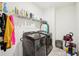 Functional laundry room featuring modern black washer and dryer with wire shelving at 939 Brittfield Way, Loganville, GA 30052