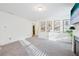 Bright living room with neutral walls, plush gray carpet, fireplace, and decorative art at 939 Brittfield Way, Loganville, GA 30052