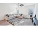 Spacious living room features a sectional sofa, entertainment center, and ceiling fan at 939 Brittfield Way, Loganville, GA 30052