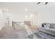Bright and airy upstairs loft with a cozy sofa, carpeted floors, and lots of natural light at 939 Brittfield Way, Loganville, GA 30052