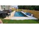 Backyard view of a refreshing swimming pool and patio furniture, perfect for outdoor relaxation and entertainment at 939 Brittfield Way, Loganville, GA 30052