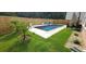 Backyard view of a refreshing swimming pool and manicured lawn, perfect for outdoor relaxation and entertainment at 939 Brittfield Way, Loganville, GA 30052