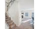 Carpeted staircase with wrought iron railings leading to the bright, open living area at 939 Brittfield Way, Loganville, GA 30052