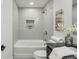 Updated bathroom with a sleek white tub and tiled walls at 863 Birch St, Forest Park, GA 30297