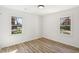Sun-filled bedroom with two windows and wood-look flooring at 863 Birch St, Forest Park, GA 30297