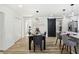 Elegant dining room with modern lighting, stylish barn door, and open access to the kitchen at 863 Birch St, Forest Park, GA 30297