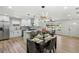 Well-lit dining space with modern lighting, flowing into a stylish kitchen, ideal for entertaining at 863 Birch St, Forest Park, GA 30297