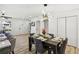 Open dining area featuring contemporary lighting and seamlessly flowing into the living space at 863 Birch St, Forest Park, GA 30297