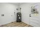 Bright laundry room features wood-look flooring and access to outdoors at 863 Birch St, Forest Park, GA 30297