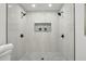 Walk-in shower boasts dual shower heads, mosaic tile flooring, and built-in shelf at 863 Birch St, Forest Park, GA 30297