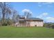 View of the home's backyard with a wooden deck at 100 Cowan Trl, Stockbridge, GA 30281