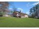 View of the home's backyard with a wooden deck at 100 Cowan Trl, Stockbridge, GA 30281