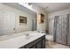 Bathroom with large vanity, toilet, shower with curtain, and tile flooring at 100 Cowan Trl, Stockbridge, GA 30281