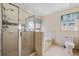 Bathroom with glass enclosed shower, soaking tub, and toilet at 100 Cowan Trl, Stockbridge, GA 30281