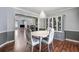 Open-concept dining room with hardwood floors and view of the living room at 100 Cowan Trl, Stockbridge, GA 30281