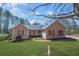 Charming ranch-style home with a well-manicured lawn, inviting curb appeal, and a cozy front porch at 100 Cowan Trl, Stockbridge, GA 30281