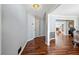 Inviting hallway features hardwood floors and neutral paint, leading to a bright, open living space at 100 Cowan Trl, Stockbridge, GA 30281