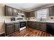 Kitchen features dark cabinets, white countertops, and hardwood floors at 100 Cowan Trl, Stockbridge, GA 30281