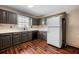 Kitchen features dark cabinets, white countertops, and stainless steel appliances at 100 Cowan Trl, Stockbridge, GA 30281