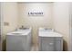 Laundry room featuring a washer, dryer, and Laundry sign at 100 Cowan Trl, Stockbridge, GA 30281