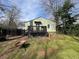 Backyard view of a home featuring a small deck with railing and backyard access at 3020 Harold Se Ave, Atlanta, GA 30316