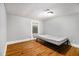 A bedroom with hardwood floors, a window, and a small air conditioning unit at 3020 Harold Se Ave, Atlanta, GA 30316