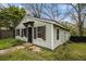 Cozy home with light green siding, dark shutters, and simple landscaping on a sunny day at 3020 Harold Se Ave, Atlanta, GA 30316