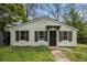 Quaint, single-story home featuring light green siding, dark shutters, and a simple covered porch at 3020 Harold Se Ave, Atlanta, GA 30316
