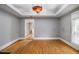 Open living room with hardwood floors, decorative lighting, and large window at 3020 Harold Se Ave, Atlanta, GA 30316