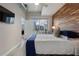 This bedroom features a wood accent wall, balcony access, and a view of the city skyline at 923 Peachtree Ne St # 930, Atlanta, GA 30309