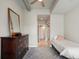 Bedroom with dresser, wood floors, and a view of the closet and bathroom at 923 Peachtree Ne St # 930, Atlanta, GA 30309