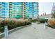Landscaped common area in front of modern building with concrete walkway and various plants and shrubs at 923 Peachtree Ne St # 930, Atlanta, GA 30309