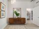 Elegant hallway with a stylish mirror, wooden console, and a glimpse into a modern bathroom at 923 Peachtree Ne St # 930, Atlanta, GA 30309