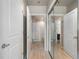 Hallway featuring wood floors leading to a bathroom and closet at 923 Peachtree Ne St # 930, Atlanta, GA 30309