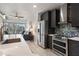 Sleek kitchen featuring stainless steel appliances, dark cabinetry, and an open view to the living area at 923 Peachtree Ne St # 930, Atlanta, GA 30309