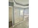 Bathroom featuring a standalone shower and a soaking tub, both tiled in white at 971 Martin Se St, Atlanta, GA 30315